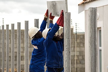 Construction Workers Erecting Concrete Panels
